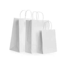 Photo of Blank paper bags on white background. Mockup for design
