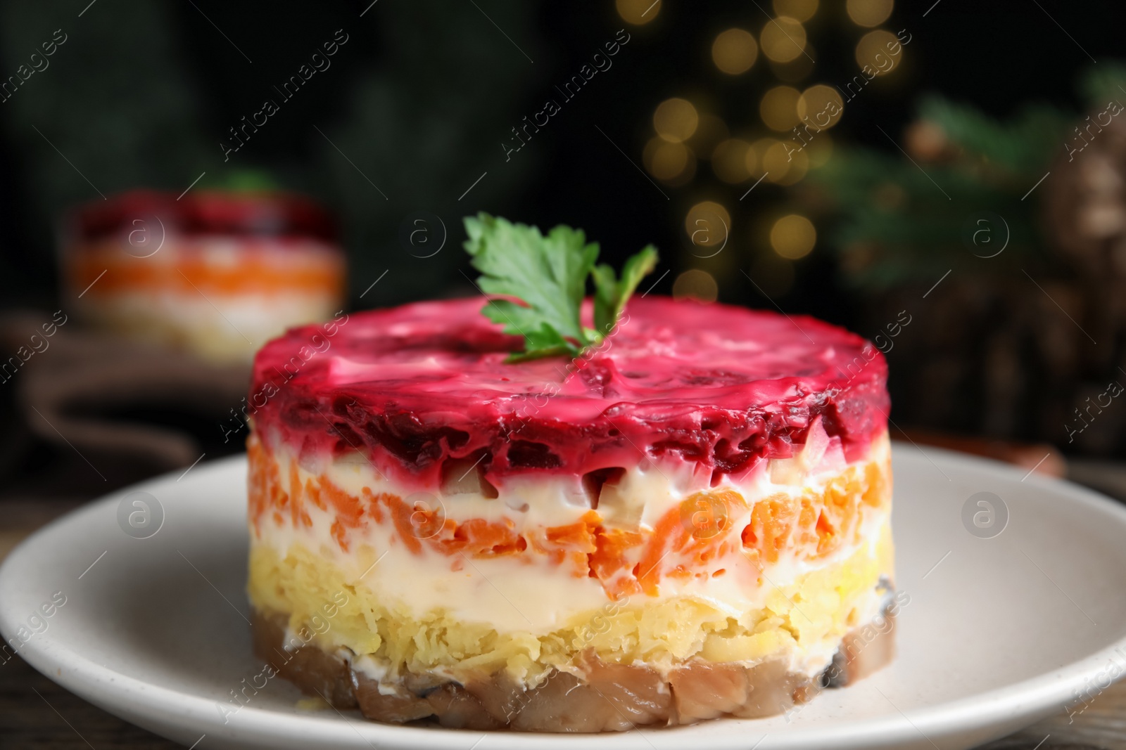 Photo of Herring under fur coat on plate, closeup. Traditional russian salad