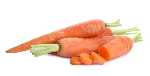 Photo of Whole and sliced ripe carrots on white background