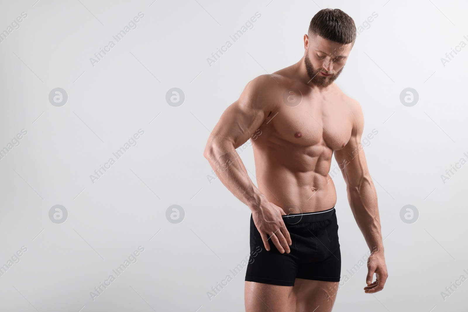 Photo of Young man is stylish black underwear on light grey background. Space for text