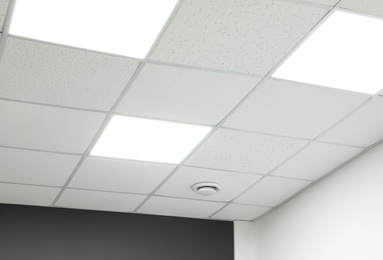 Photo of White ceiling with lighting in office room