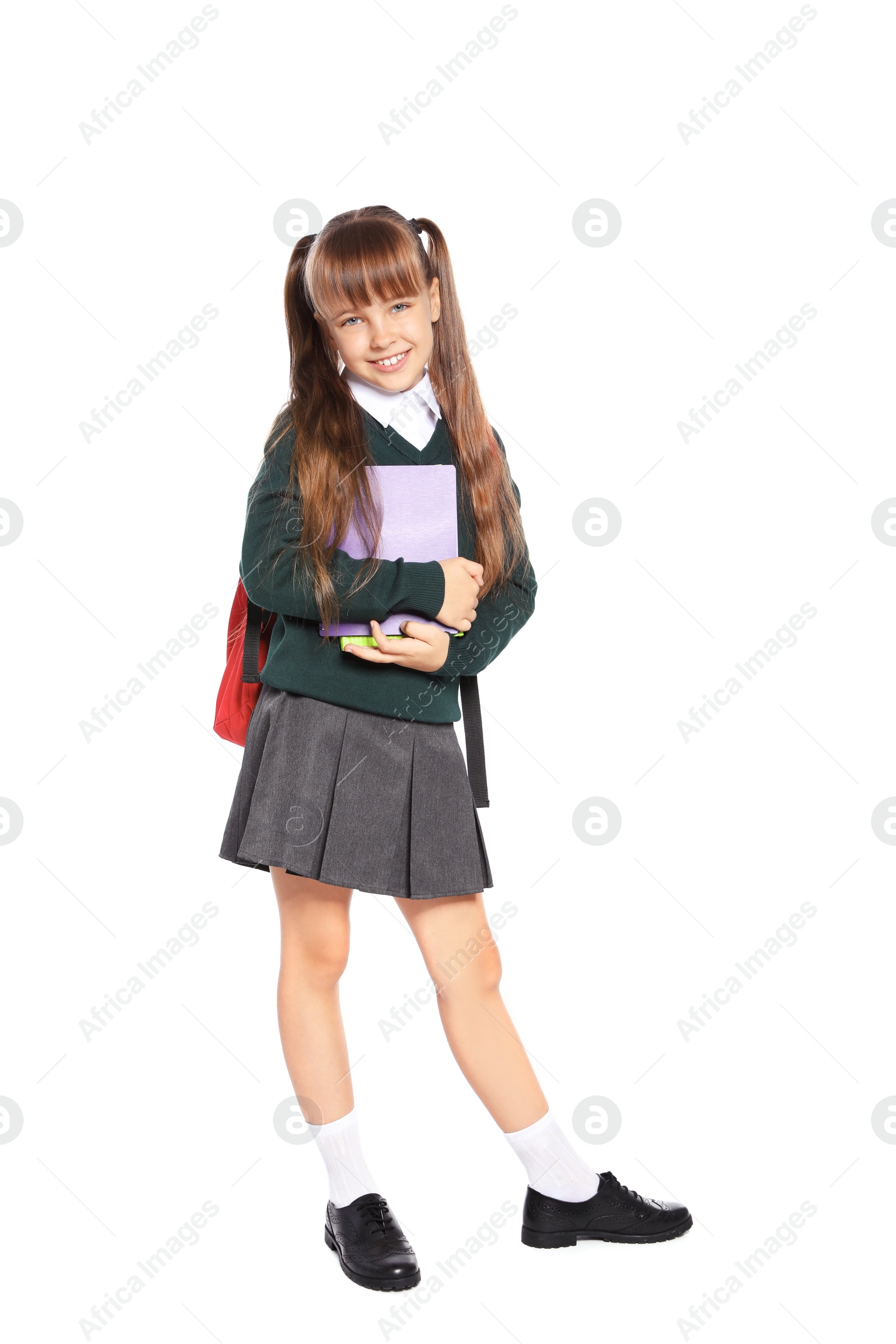 Photo of Little girl in stylish school uniform on white background