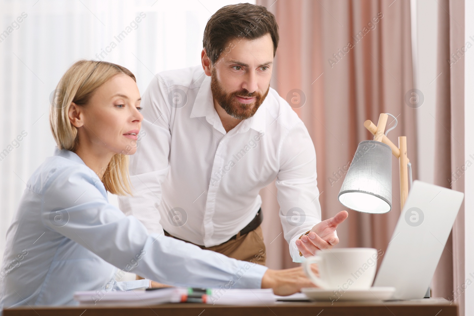 Photo of Businesspeople working with documents at wooden table in office