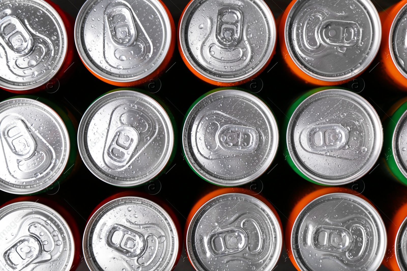 Photo of Energy drink in wet cans, top view. Functional beverage