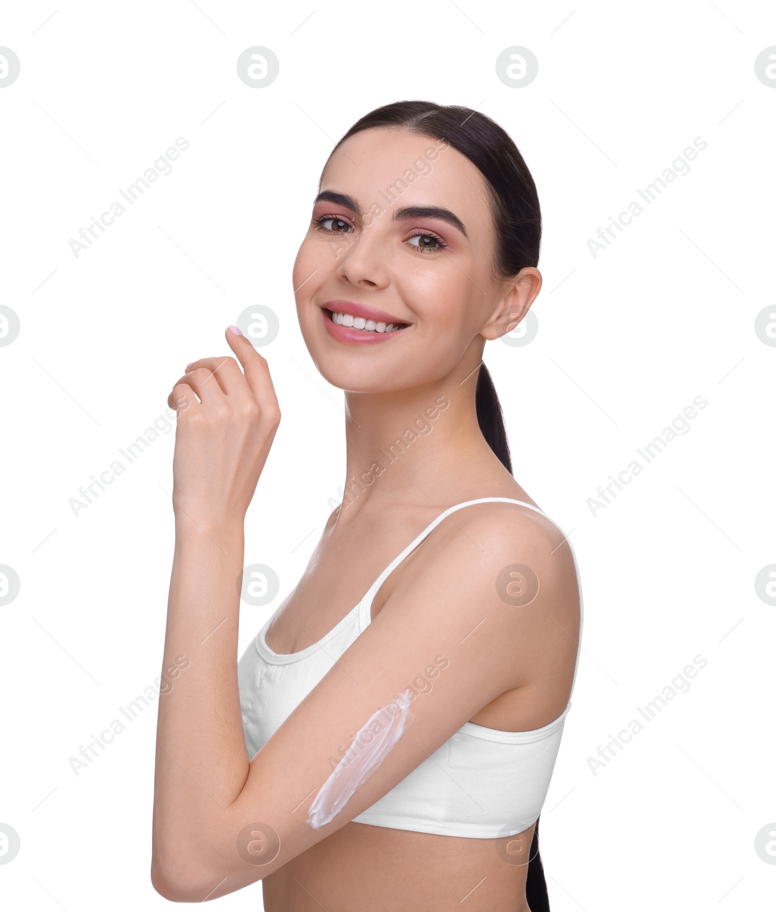 Photo of Beautiful woman with smear of body cream on her arm against white background