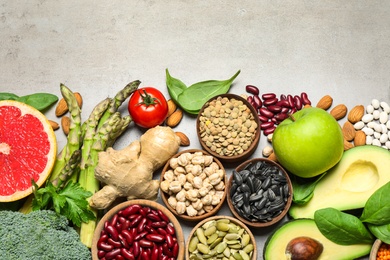 Photo of Flat lay composition with different vegetables, seeds and fruits on grey table, space for text. Healthy diet