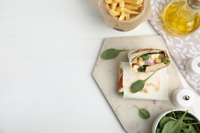 Photo of Delicious shawarma with chicken and fresh vegetables served on white wooden table, flat lay. Space for text