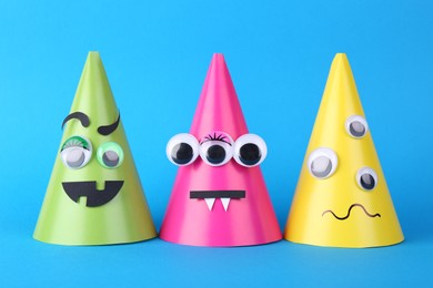 Spooky paper monsters on light blue background. Halloween decoration