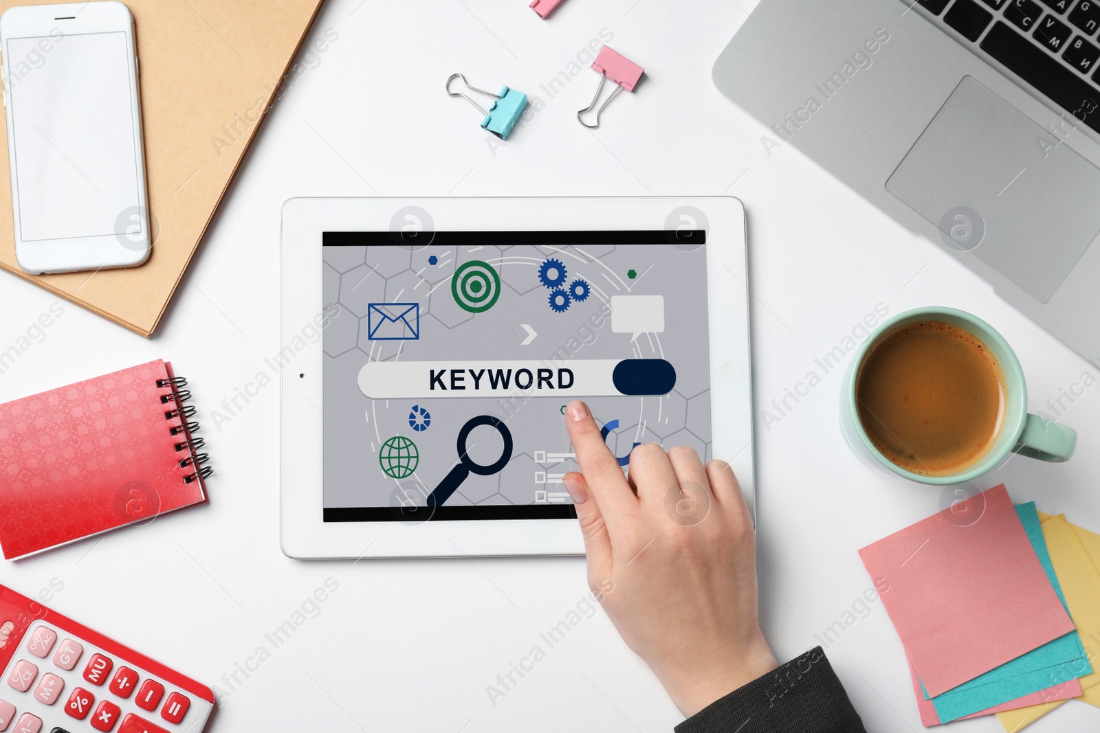 Image of Woman with tablet searching for keyword at white table, top view