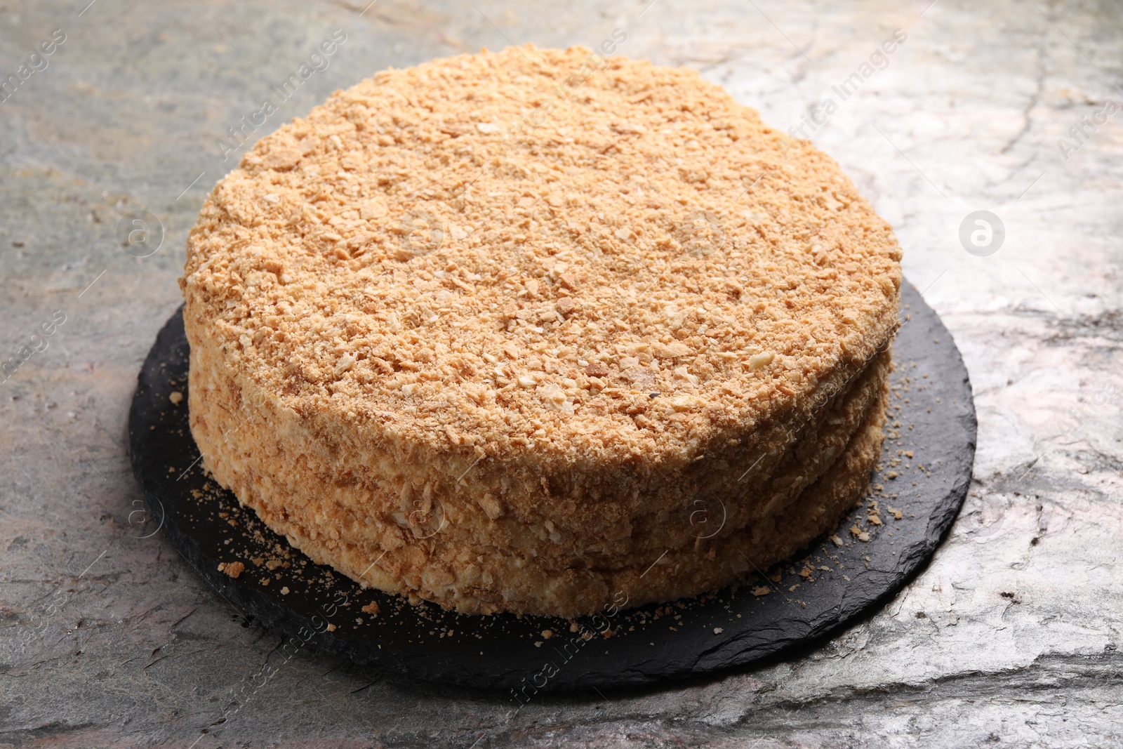 Photo of Delicious Napoleon cake on gray table, closeup