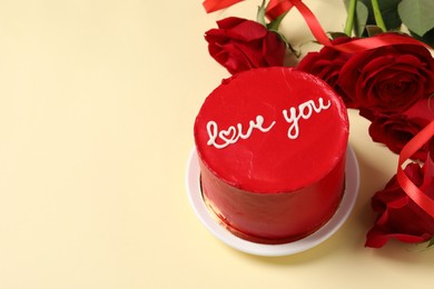 Bento cake with text Love You and red roses on beige table, space for text. St. Valentine's day surprise