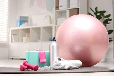 Photo of Many different sports equipment on floor indoors