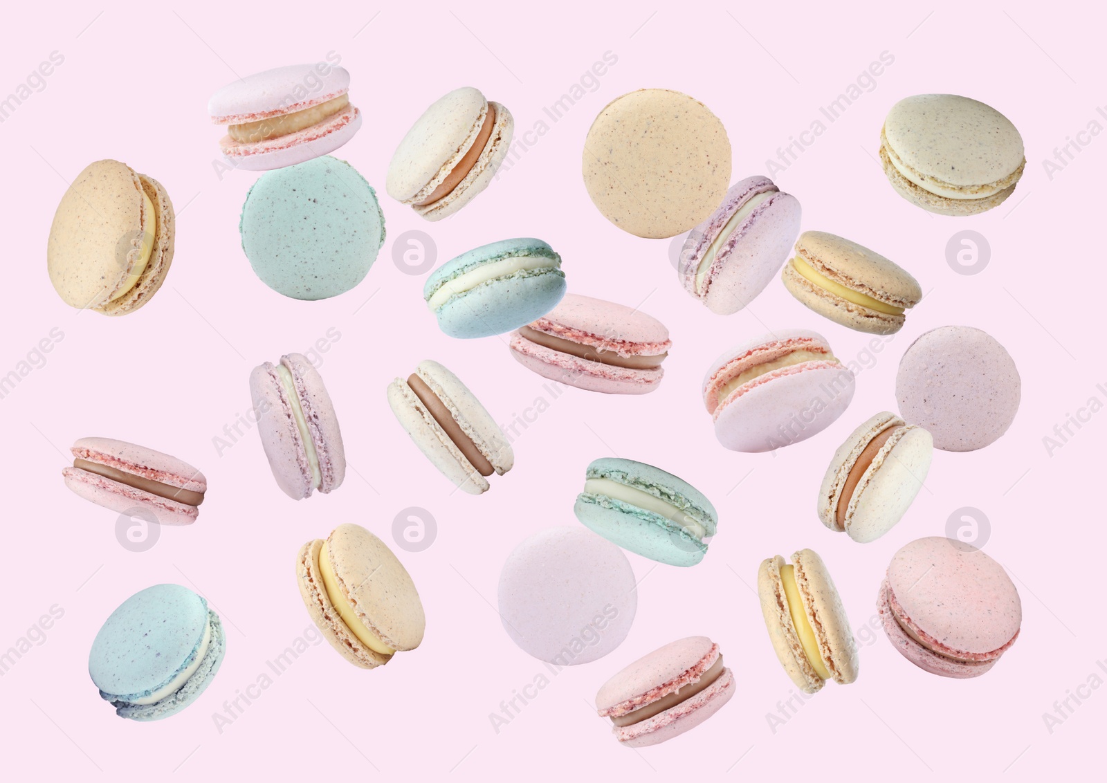 Image of Sweet delicious macarons flying on pink background