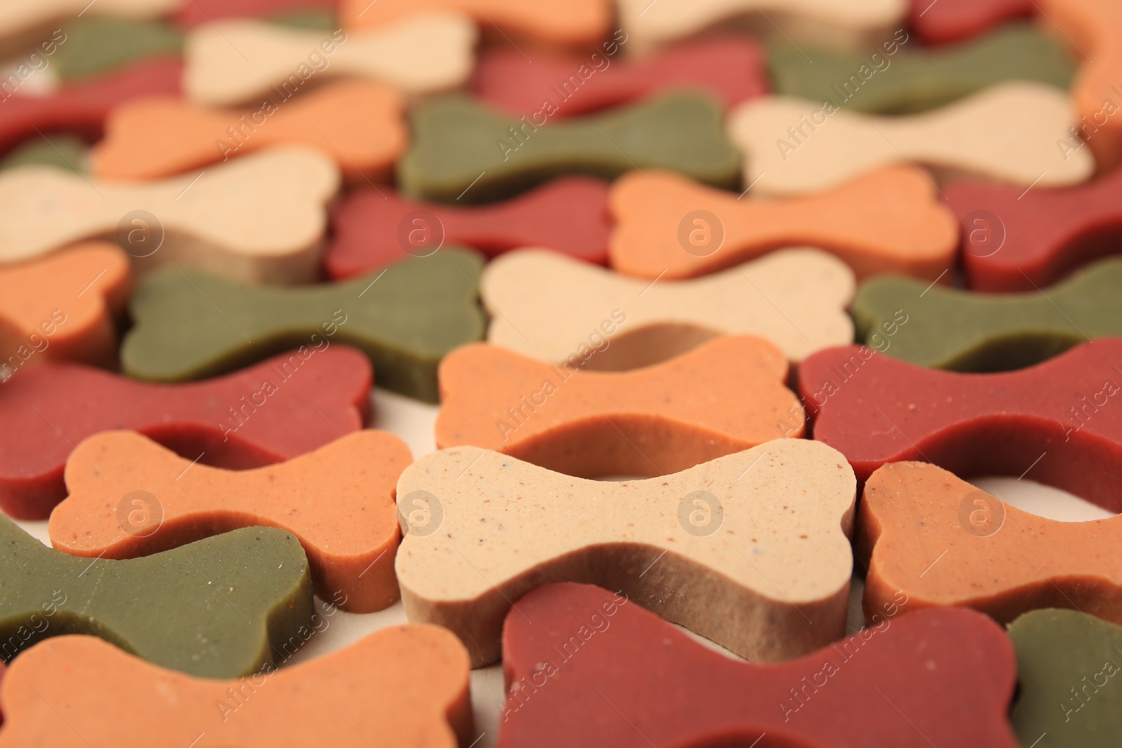 Photo of Many bone shaped vitamins for pets as background, closeup