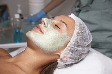 Photo of Beautiful woman with mask on her face in spa salon