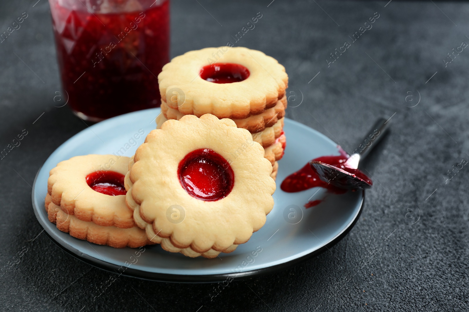 Photo of Traditional Christmas Linzer cookies with sweet jam on plate