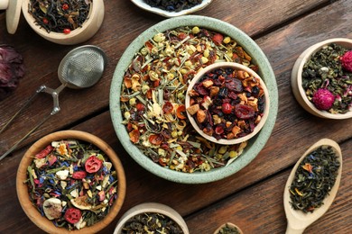 Photo of Many different herbal teas on wooden table, flat lay
