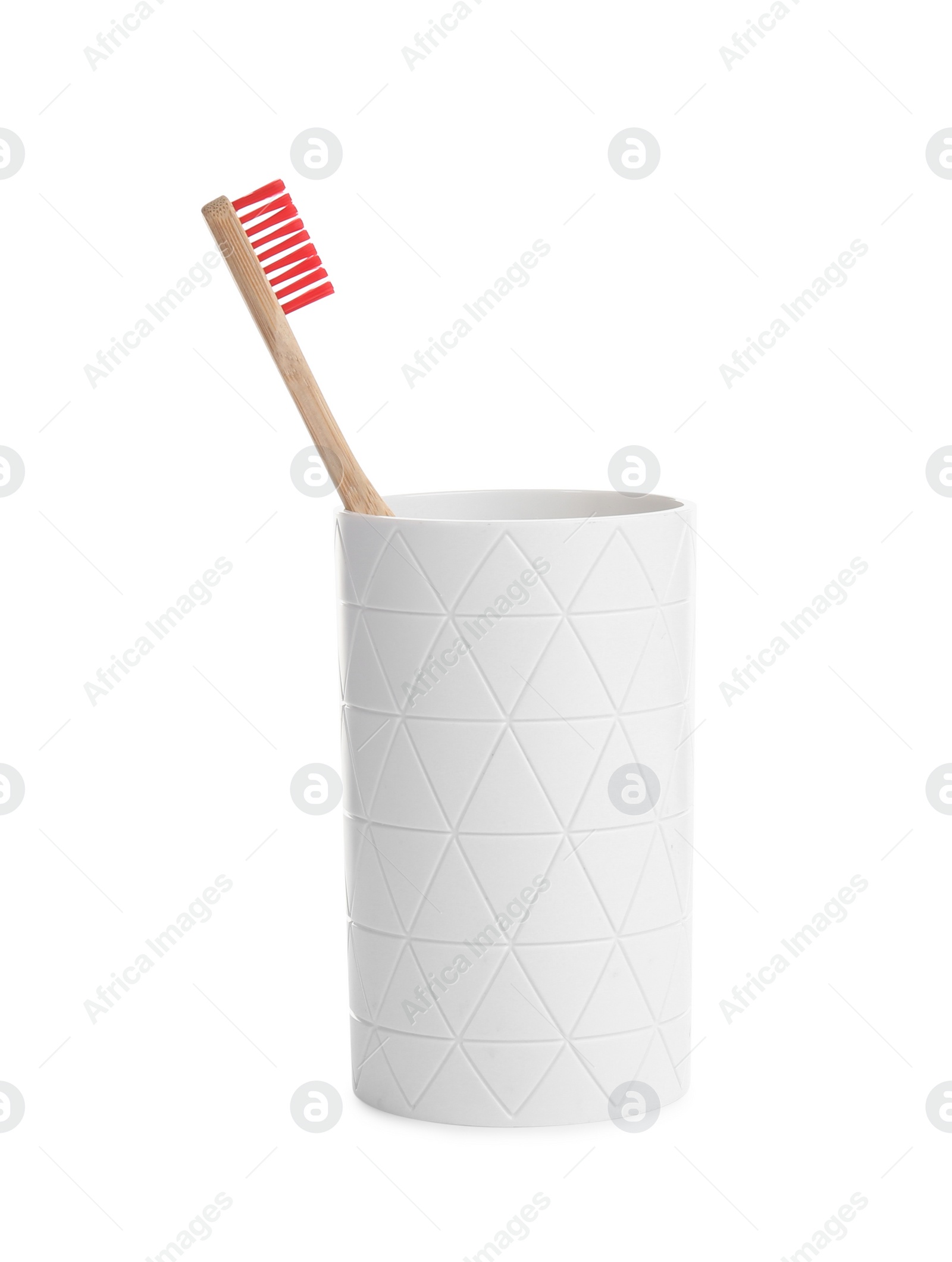 Photo of Bamboo toothbrush in holder isolated on white