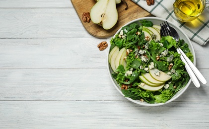 Fresh salad with pear on white wooden table, flat lay. Space for text