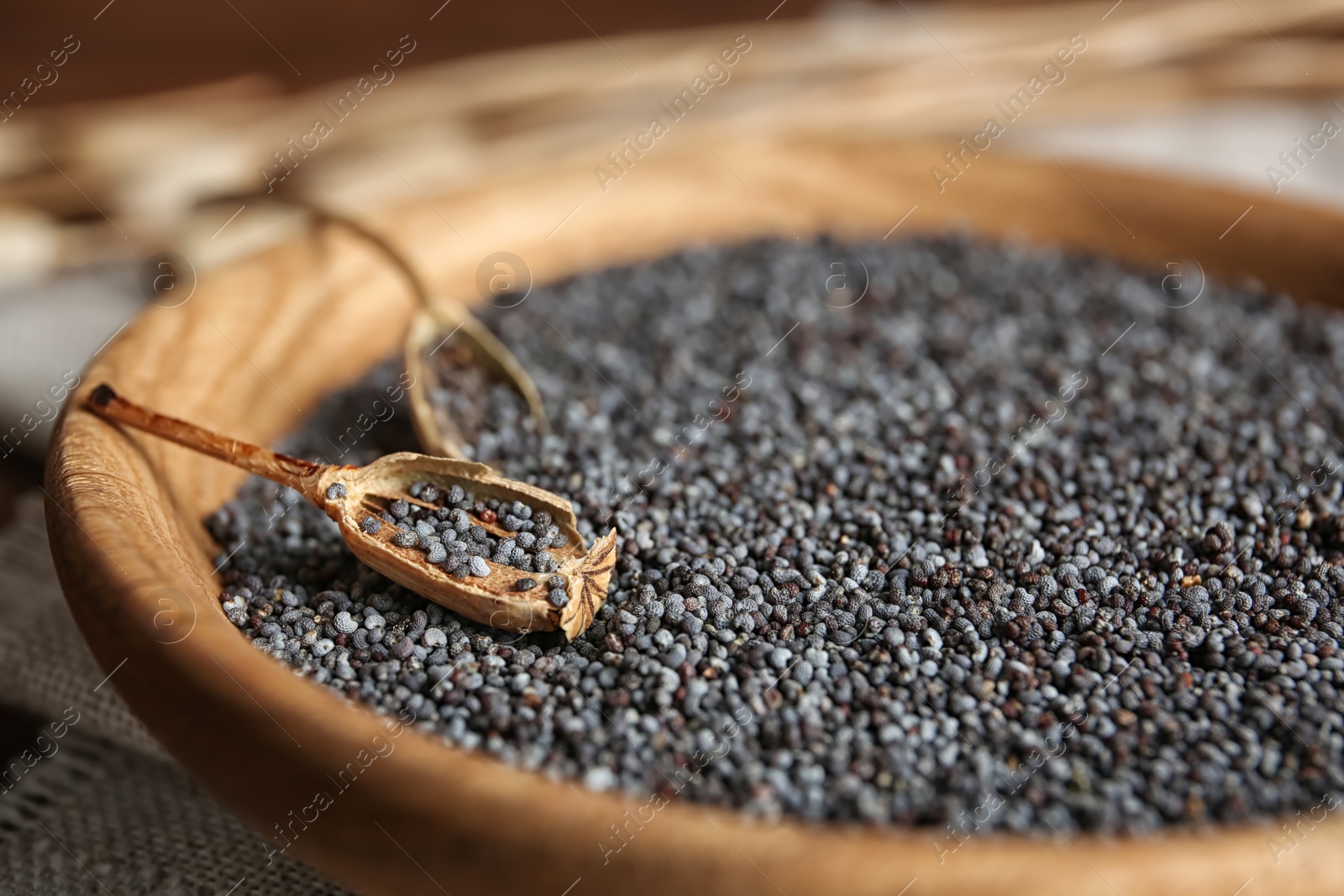 Photo of Plate with poppy seeds on table, closeup