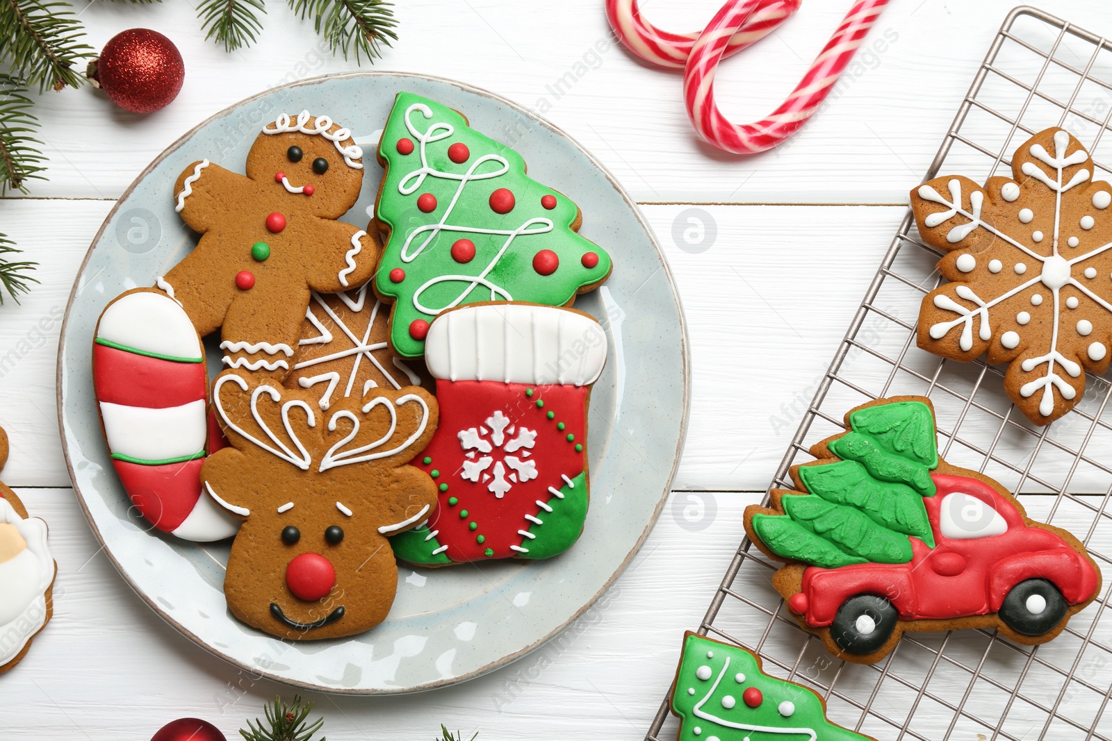 Photo of Tasty homemade Christmas cookies and decor on white wooden table, flat lay