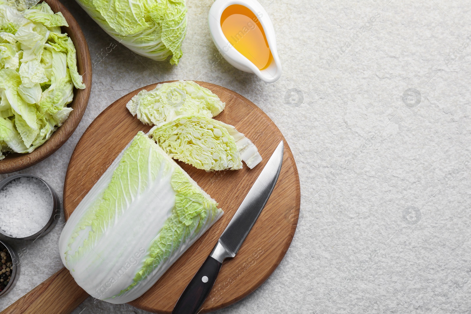 Photo of Fresh Chinese cabbages, oil and spices on light table, flat lay. Space for text