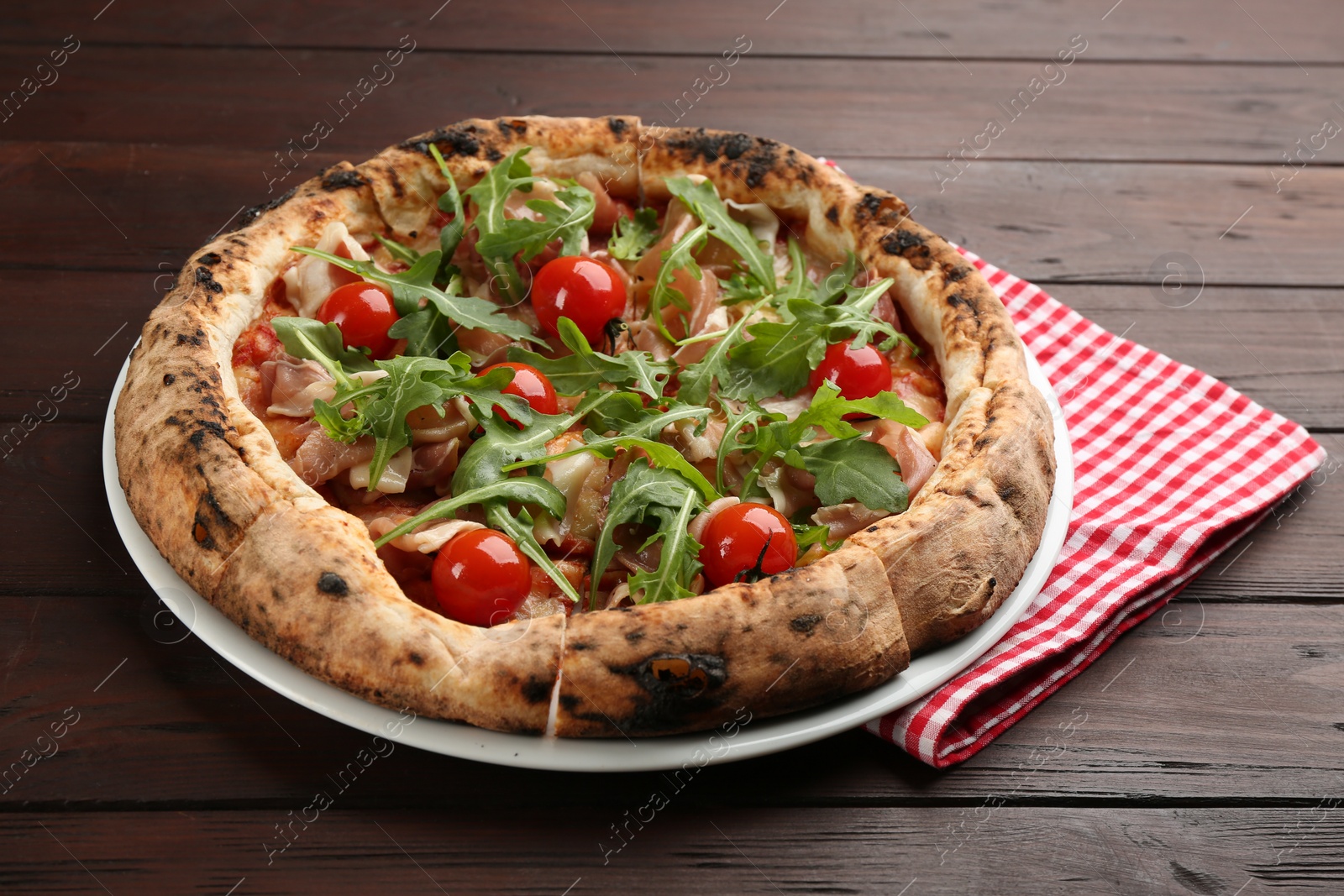 Photo of Tasty pizza with meat and arugula on wooden table