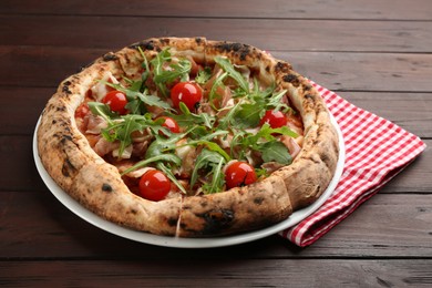 Photo of Tasty pizza with meat and arugula on wooden table