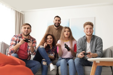 Emotional friends playing video games at home