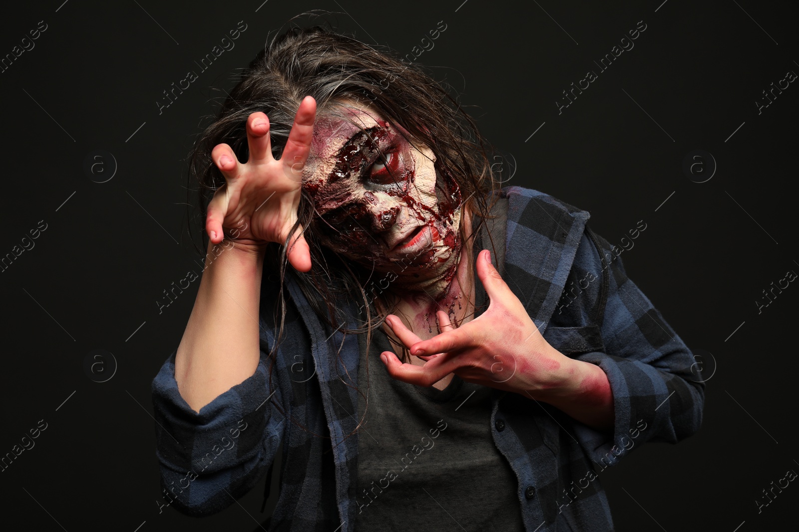 Photo of Scary zombie on dark background. Halloween monster