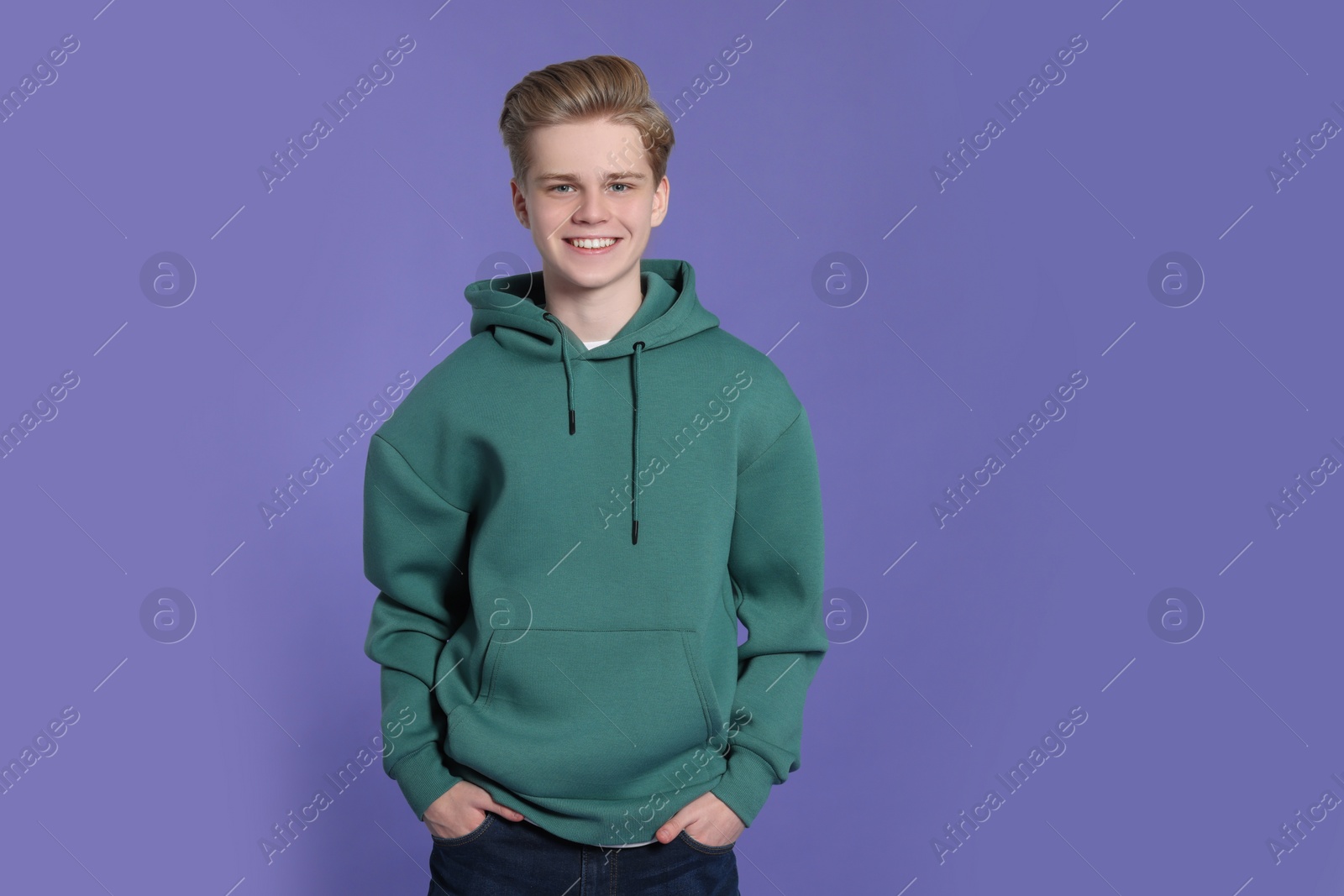 Photo of Portrait of teenage boy on purple background