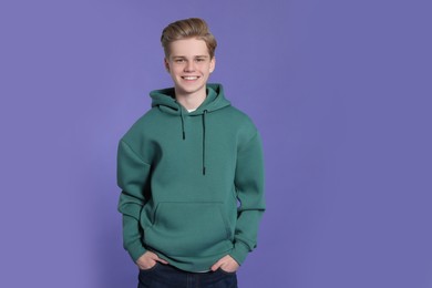 Photo of Portrait of teenage boy on purple background