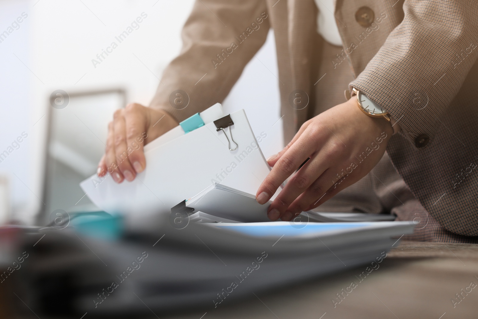 Photo of Businesswoman working with documents at office table, closeup