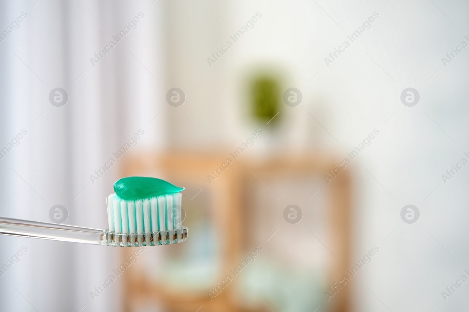 Photo of Toothbrush with paste on blurred background, closeup