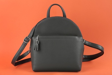 Photo of Stylish leather urban backpack on orange background
