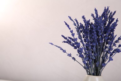 Photo of Bouquet of beautiful preserved lavender flowers on beige background, space for text