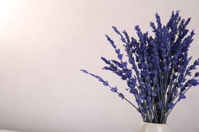 Bouquet of beautiful preserved lavender flowers on beige background, space for text