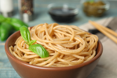 Photo of Tasty buckwheat noodles in bowl on table, closeup