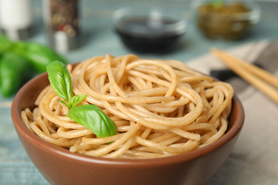 Tasty buckwheat noodles in bowl on table, closeup