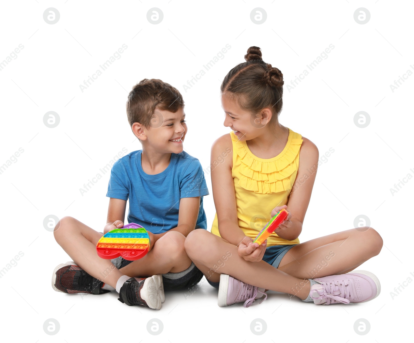 Photo of Children with pop it fidget toys on white background