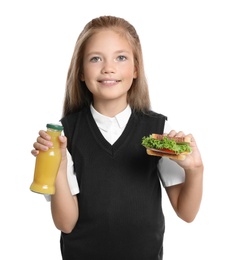 Photo of Happy girl holding sandwich and bottle of juice on white background. Healthy food for school lunch