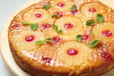 Photo of Tasty pineapple cake with cherries and mint on white table, closeup
