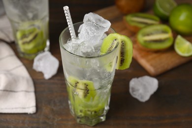 Photo of Glass of refreshing drink with kiwi on table, closeup