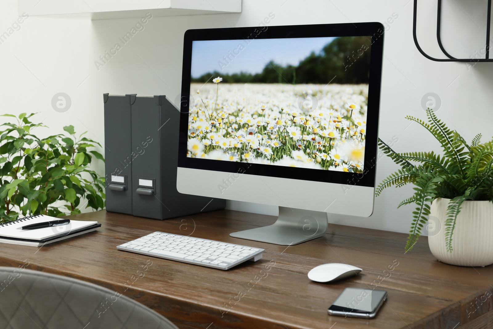 Photo of Cozy workspace with computer on wooden desk at home