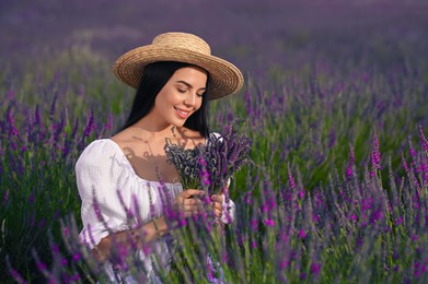 Photo of Beautiful young woman with bouquet in lavender field