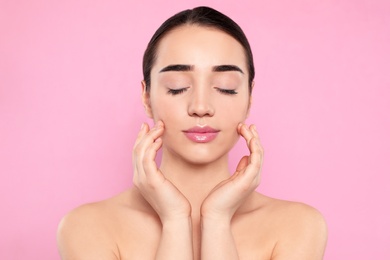 Photo of Portrait of young woman with beautiful face against color background