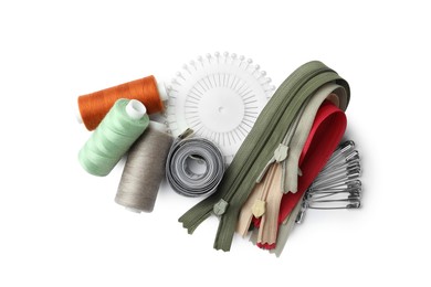 Photo of Spools of threads and sewing tools on white background, top view