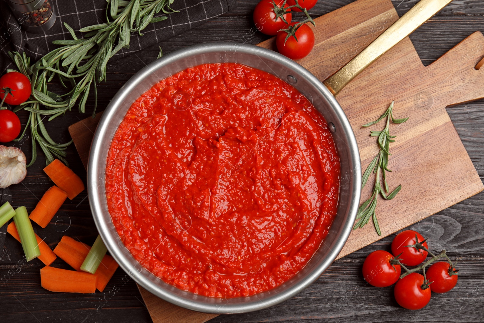 Photo of Flat lay composition with delicious tomato sauce on black wooden table