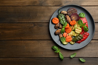 Photo of Delicious grilled vegetables on wooden table, flat lay. Space for text