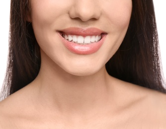 Photo of Young woman with beautiful smile on white background, closeup. Teeth whitening